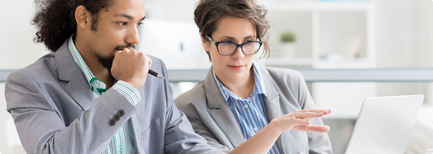 Recruiters reviewing candidates on a laptop